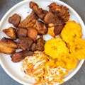 Warrior Fried pork with 3 slice of plantains and pikliz...